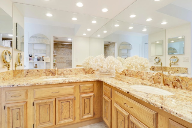 bathroom with vanity and a shower with door