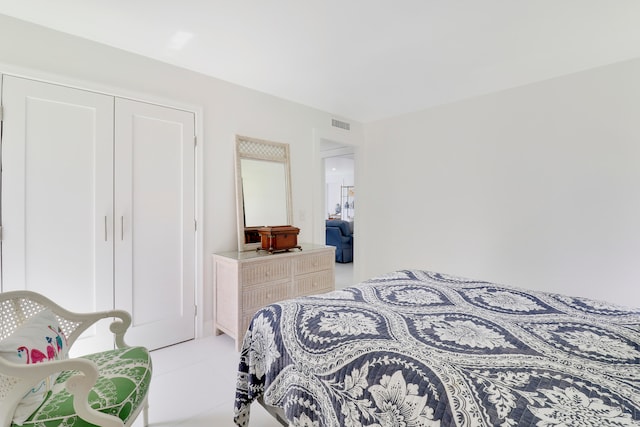 bedroom with a closet and light tile patterned floors