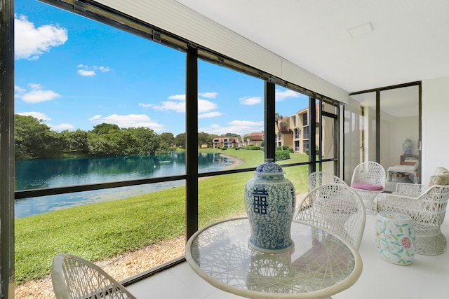 sunroom / solarium with a water view