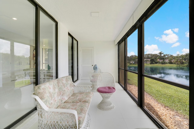 sunroom with plenty of natural light and a water view