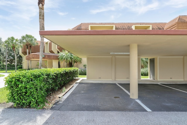 view of vehicle parking with a carport