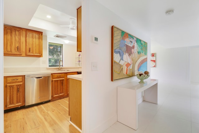 kitchen featuring ceiling fan, dishwasher, light hardwood / wood-style flooring, and sink