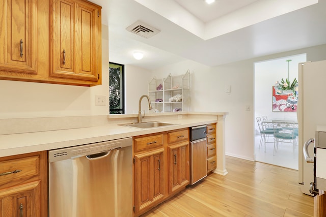 kitchen featuring light hardwood / wood-style floors, stainless steel dishwasher, and sink