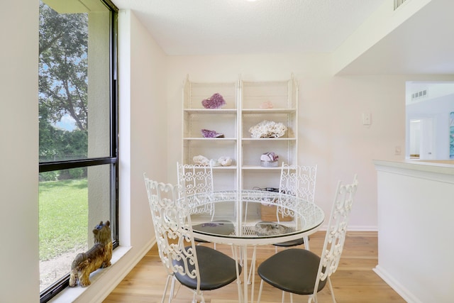 dining space featuring light wood-type flooring