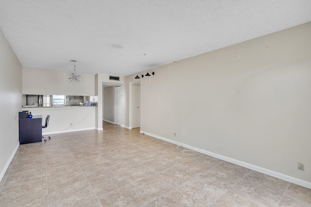 unfurnished living room featuring a textured ceiling