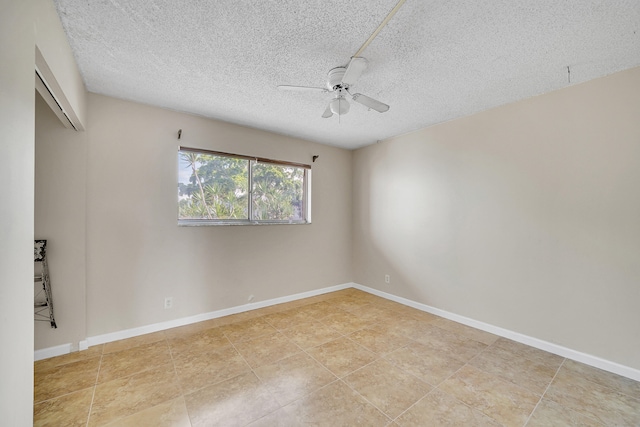 empty room featuring ceiling fan and a textured ceiling