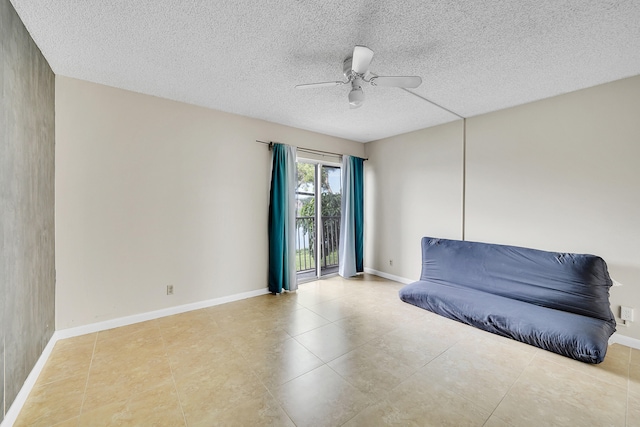 sitting room featuring ceiling fan and a textured ceiling