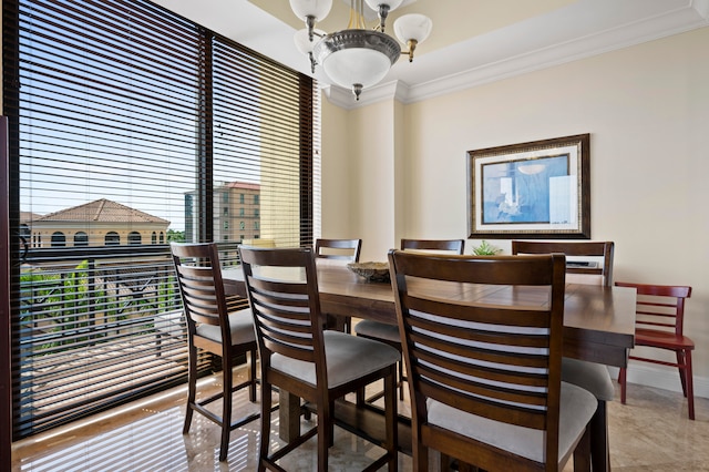 dining room with a chandelier and ornamental molding