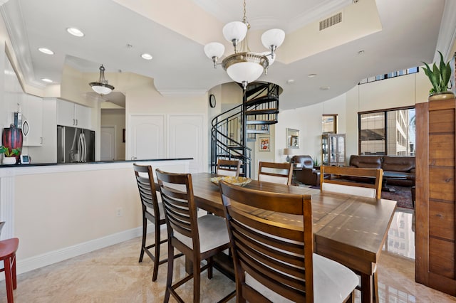 dining space featuring an inviting chandelier and ornamental molding