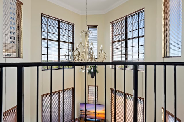 details with ornamental molding and a notable chandelier