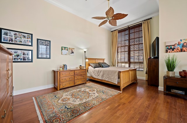 bedroom with ceiling fan, dark hardwood / wood-style flooring, and crown molding