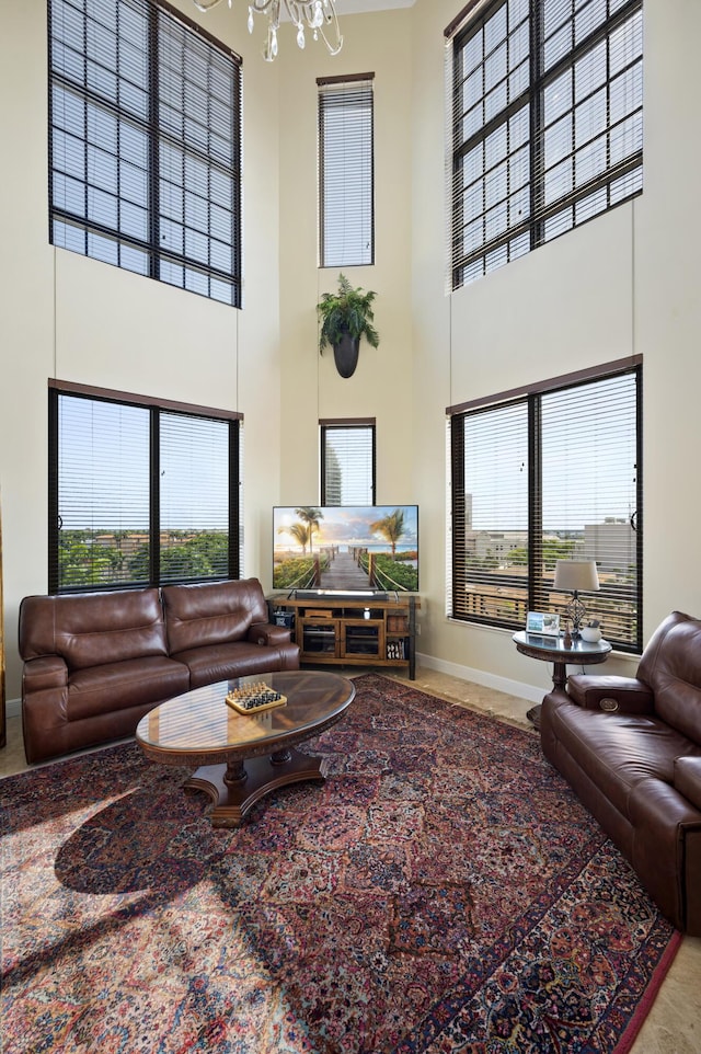 living room with a chandelier and a high ceiling