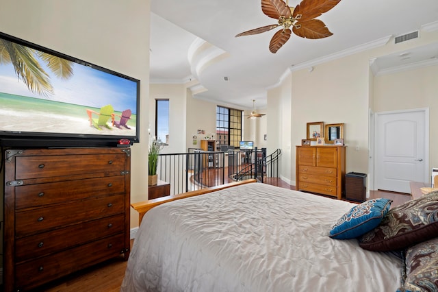 bedroom featuring hardwood / wood-style floors, ceiling fan, and crown molding