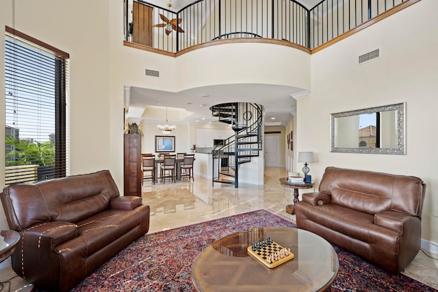 living room with a towering ceiling and a notable chandelier