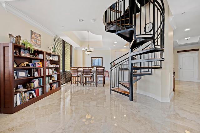 staircase with a chandelier, a raised ceiling, and ornamental molding