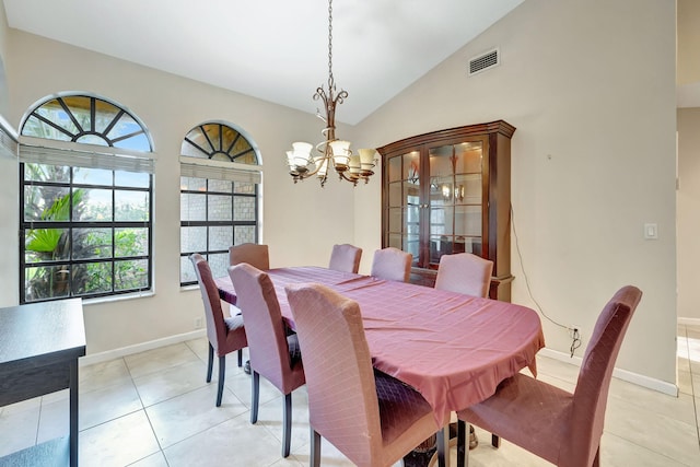 dining room featuring a chandelier, vaulted ceiling, and light tile patterned floors