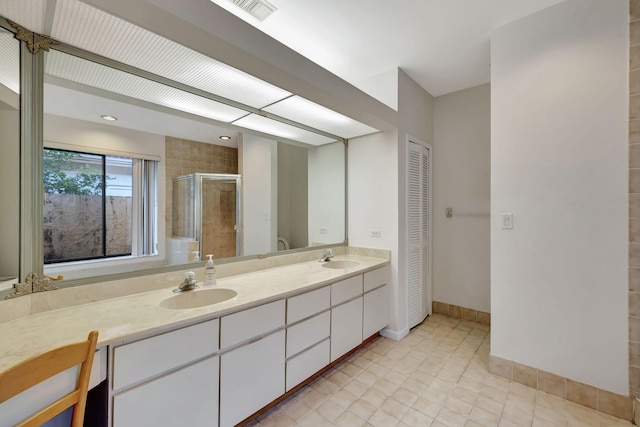 bathroom featuring vanity and a shower with shower door