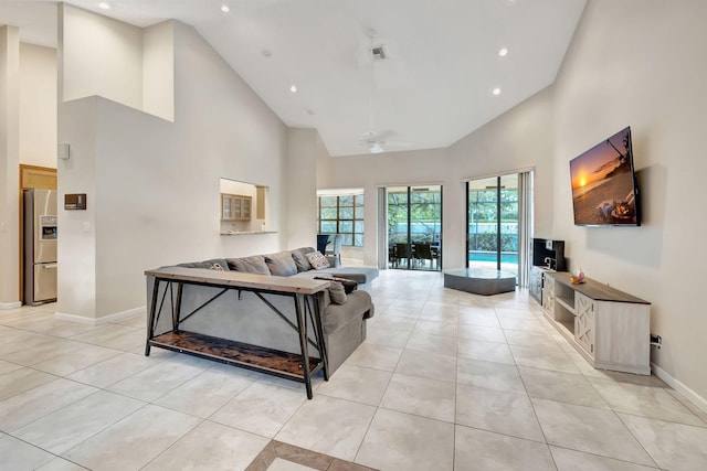 living room with ceiling fan, high vaulted ceiling, and light tile patterned floors