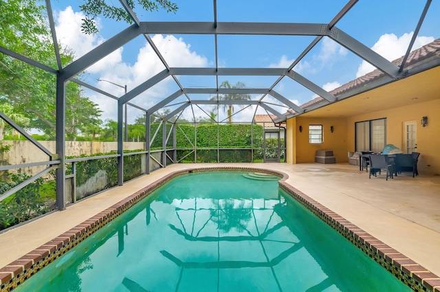 view of pool featuring a patio and glass enclosure