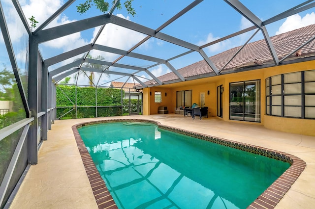 view of pool featuring a patio and glass enclosure