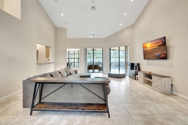 living room featuring high vaulted ceiling and light tile patterned floors