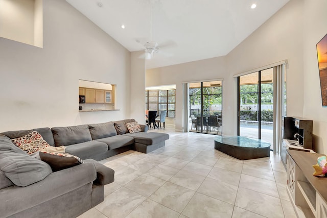 tiled living room featuring high vaulted ceiling and ceiling fan