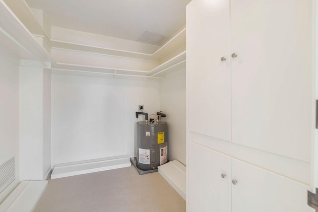 utility room featuring water heater