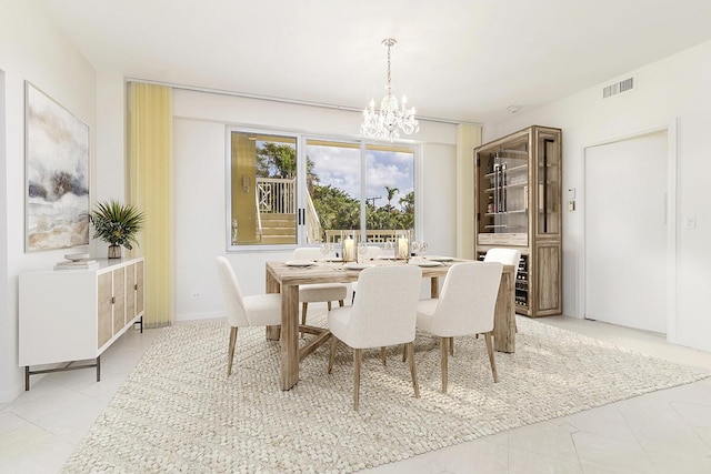 389 S Lake Dr Unit 2H, Palm Beach, FL 33480 - dining area featuring a chandelier and light tile patterned floors