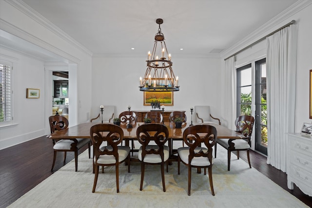 dining area with ornamental molding, hardwood / wood-style floors, and a chandelier