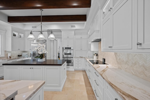 kitchen with dark stone countertops, white cabinets, beamed ceiling, and appliances with stainless steel finishes