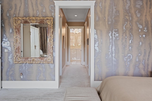 interior space featuring crown molding and ensuite bathroom