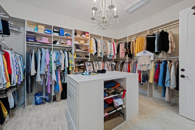 spacious closet with a chandelier