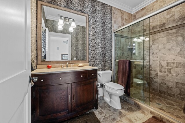 bathroom with ornamental molding, vanity, toilet, and a shower with door