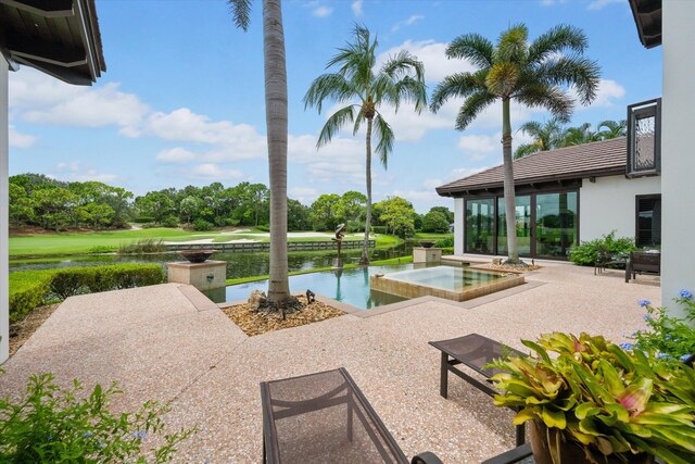 view of pool with a patio and a water view