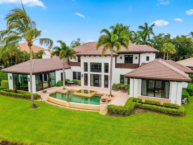 rear view of property with a yard and a patio area