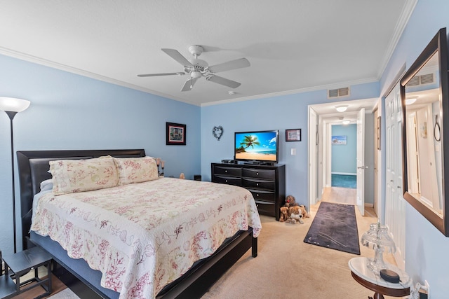 carpeted bedroom featuring crown molding and ceiling fan