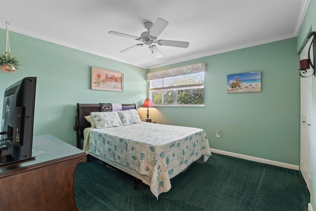 bedroom with dark colored carpet, crown molding, ceiling fan, and a closet