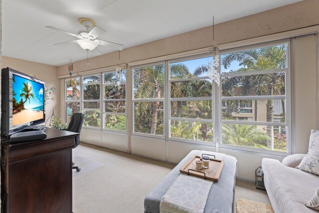 interior space featuring ceiling fan, a wealth of natural light, and light colored carpet