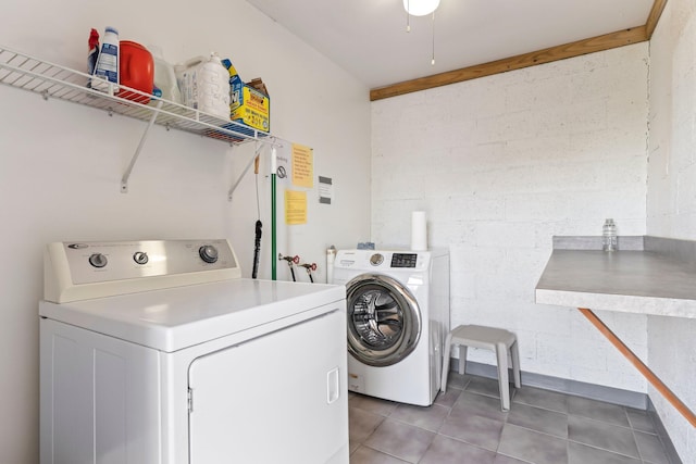 laundry area with tile patterned floors and washer and clothes dryer