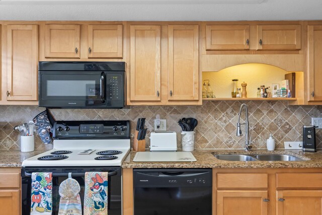 kitchen with decorative backsplash, black appliances, sink, and light stone counters