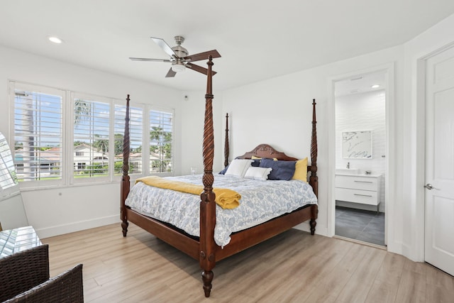 bedroom featuring light wood-type flooring, ensuite bath, and ceiling fan