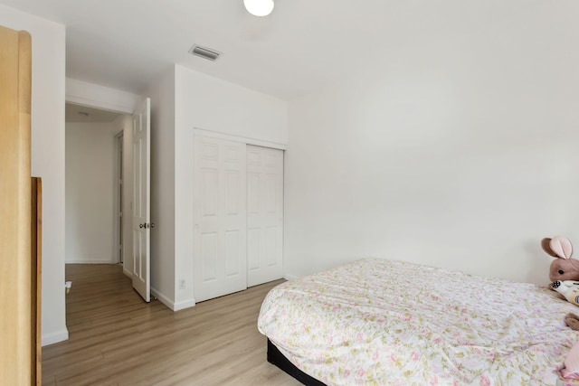 bedroom featuring light hardwood / wood-style flooring and a closet