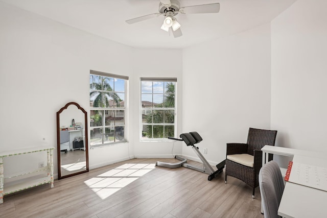 sitting room with light wood-type flooring and ceiling fan