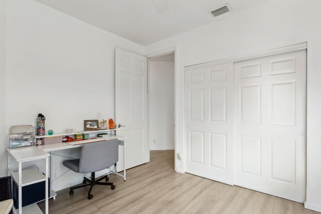 home office with light hardwood / wood-style floors