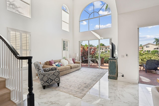 living room with a towering ceiling and a wealth of natural light