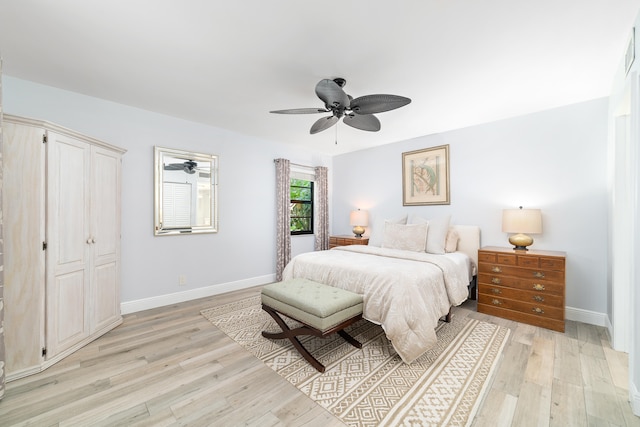 bedroom with ceiling fan, light wood-type flooring, and a closet