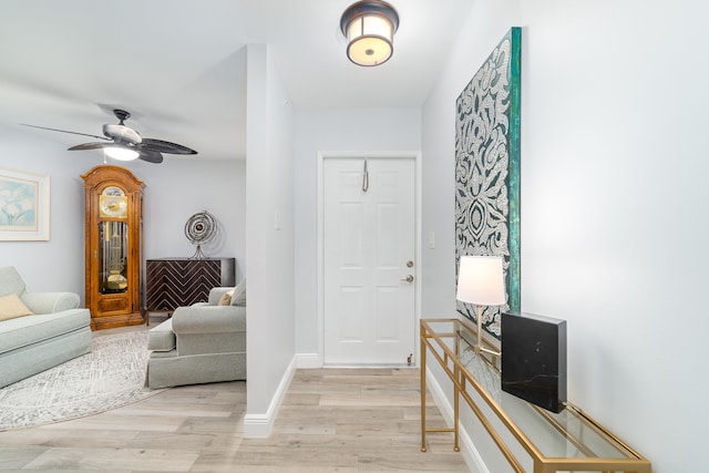 entryway with ceiling fan and light hardwood / wood-style flooring