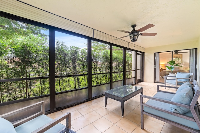 sunroom featuring ceiling fan