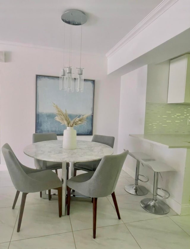 dining space with crown molding and light tile patterned floors