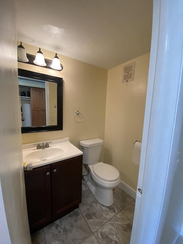 bathroom with tile patterned flooring, vanity, and toilet